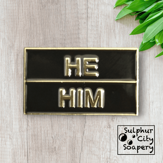 Sulphur City Soapery pronoun pin Pronoun pin in black and gold -  He / Him